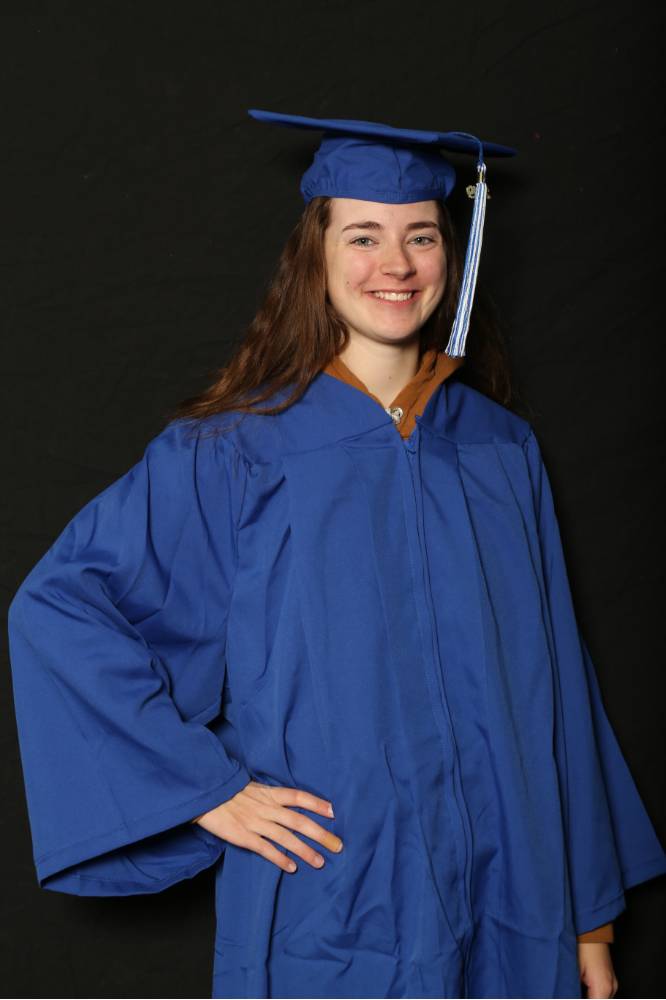 graduate posing for picture in cap and gown